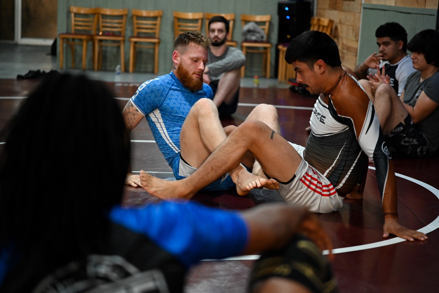 Force Jiu-Jitsu coaches demonstrating technique while adult beginners watch